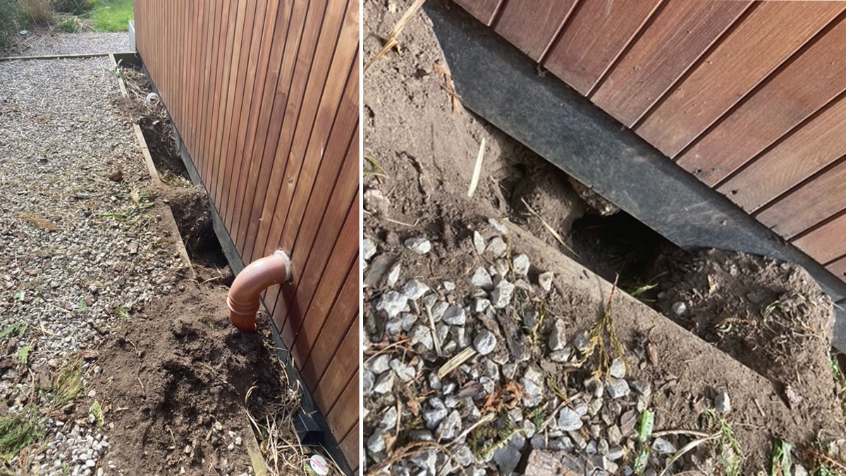 A fox hole dug under a garden office